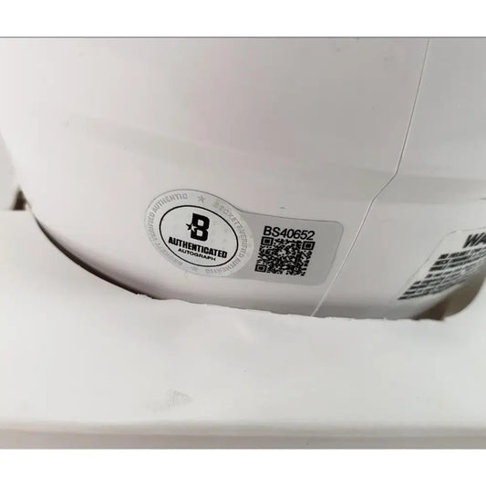 White electronic device with authentication and QR code stickers.