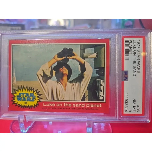 A graded 1977 Star Wars trading card featuring Luke Skywalker.