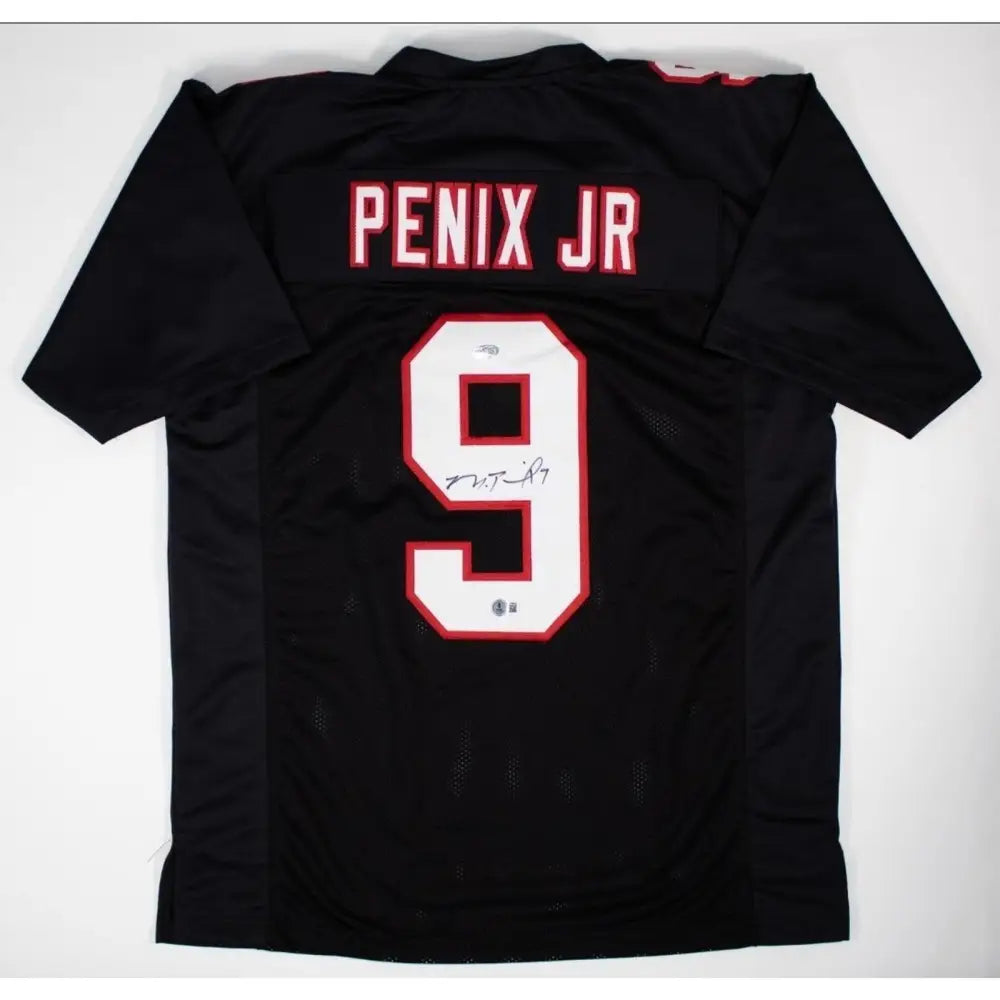 Black sports jersey with white and red number 9 and an autograph.