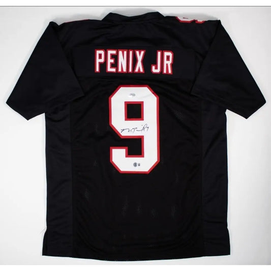 Black sports jersey with white and red number 9 and an autograph.