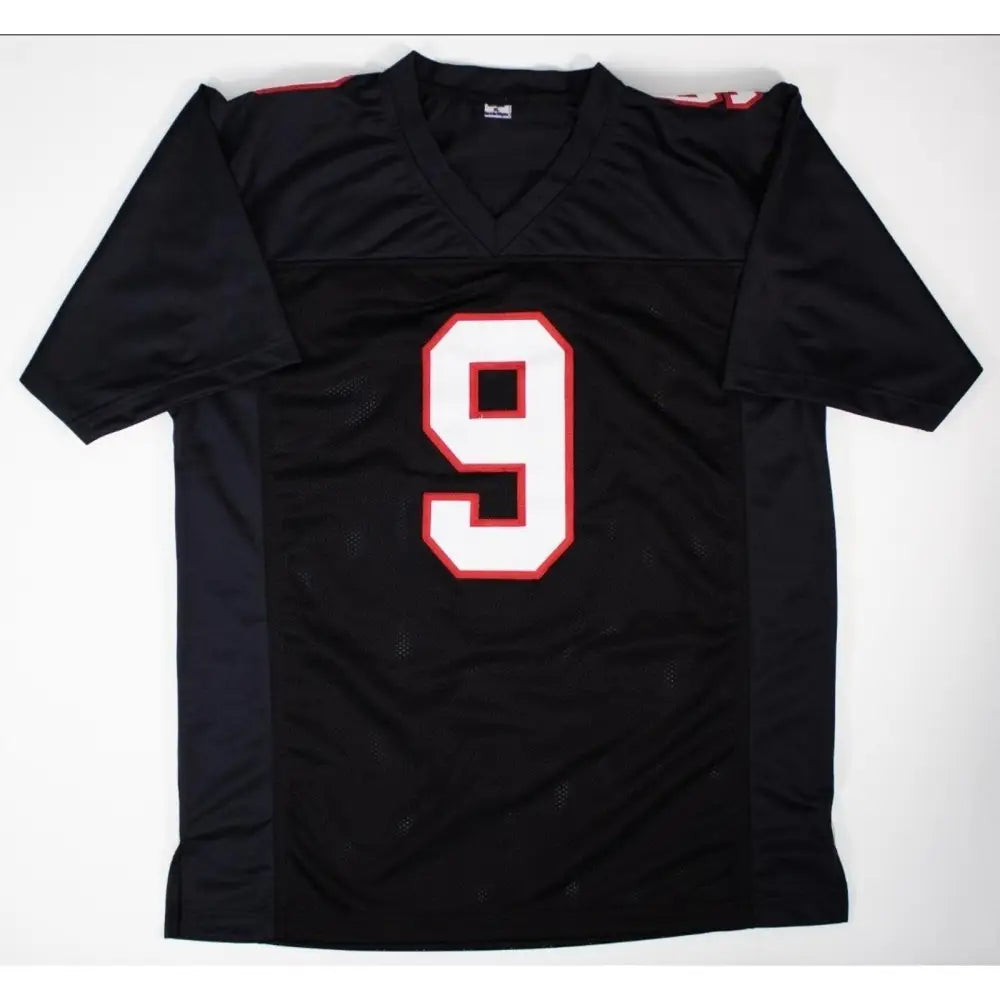 Black football jersey with a white number 9 outlined in red.