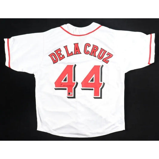White baseball jersey with red trim and numbers.