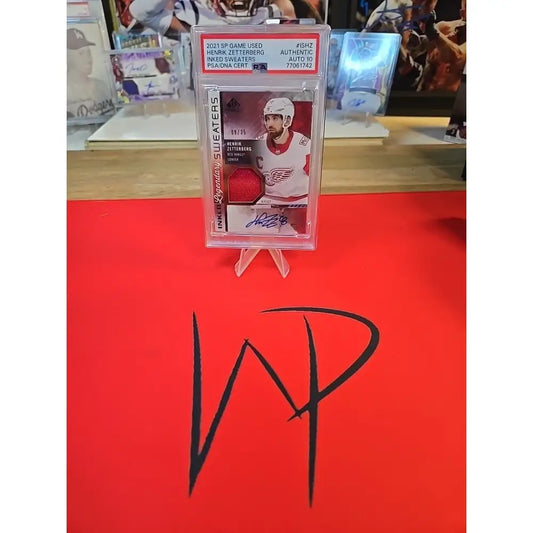 A graded hockey trading card featuring a player in a red jersey with an autograph and a patch.