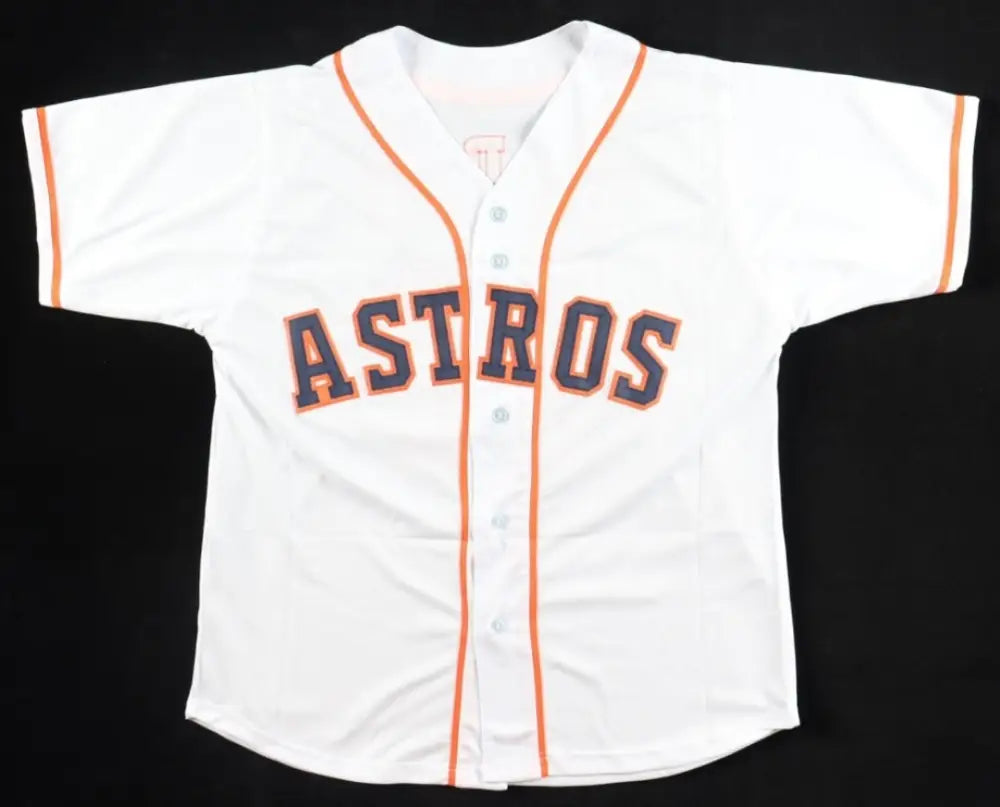White short-sleeved baseball jersey with orange trim and ’ASTROS’ in purple and orange lettering.
