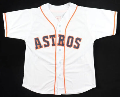 White short-sleeved baseball jersey with orange trim and ’ASTROS’ in purple and orange lettering.
