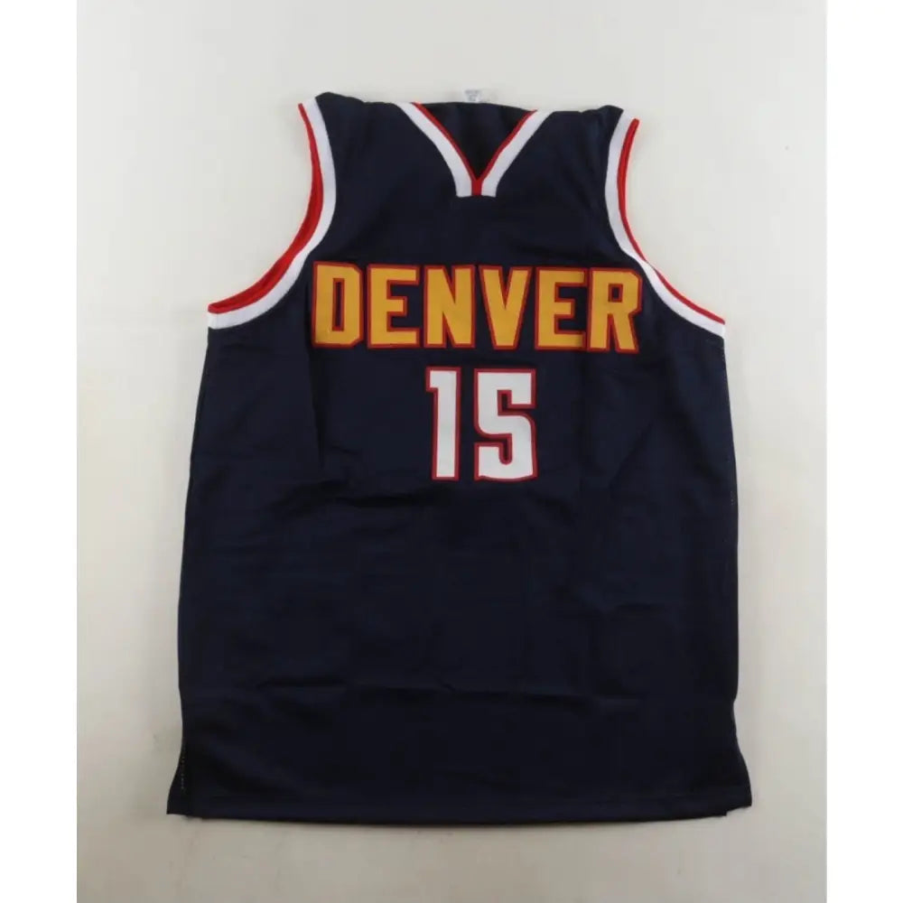Dark blue basketball jersey with ’DENVER’ and ’15’’ in gold and white, trimmed in red and white.
